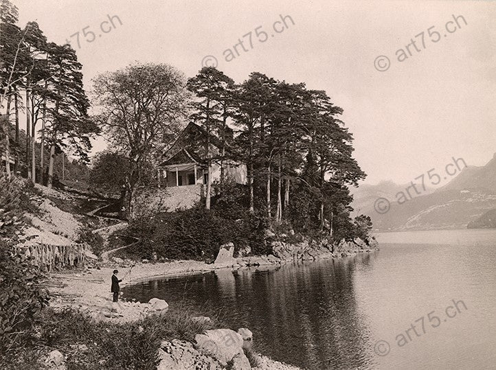 Fein restaurierte Fotografie der Kindlimord-Kapelle bei Gersau am Vierwaldstättersee, umgeben von Bäumen und Seeufer, aufgenommen um 1900.